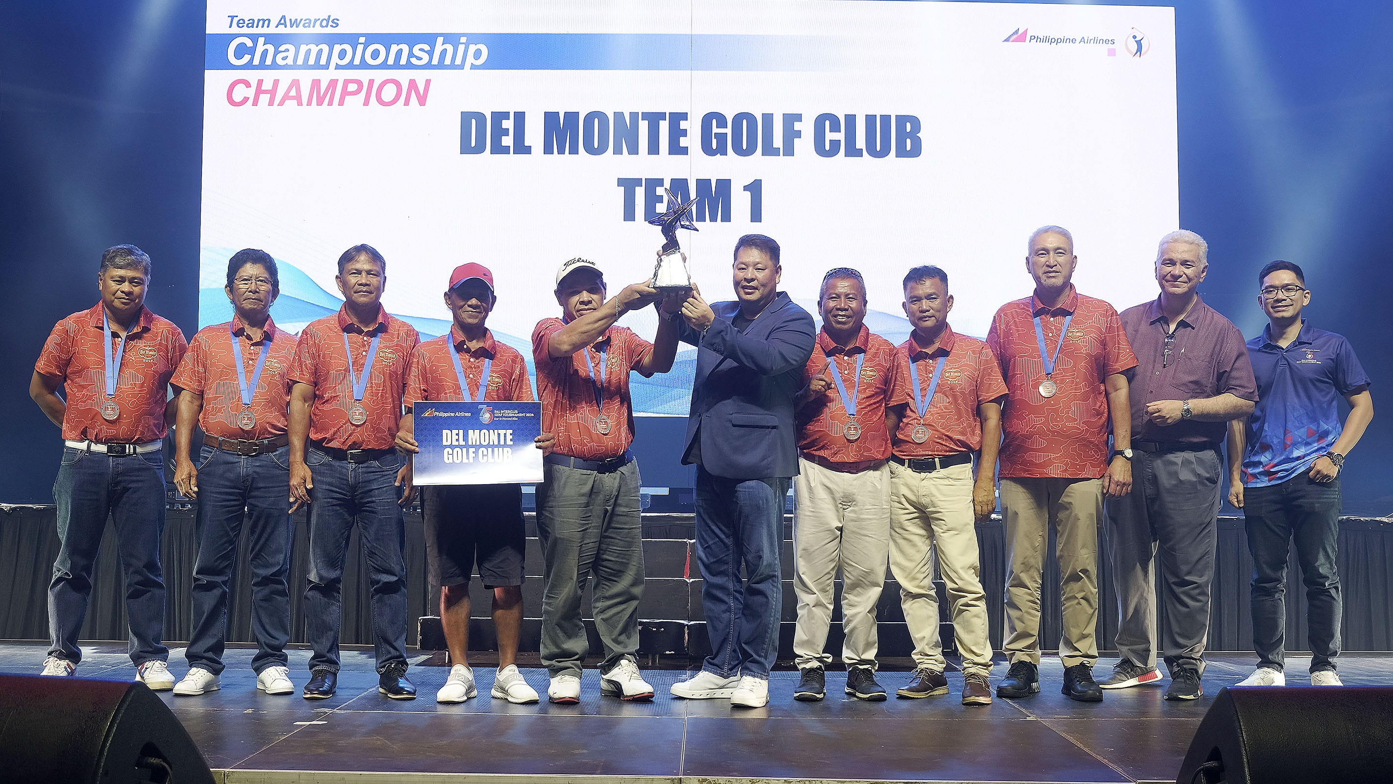 The Del Monte team receives their trophy.