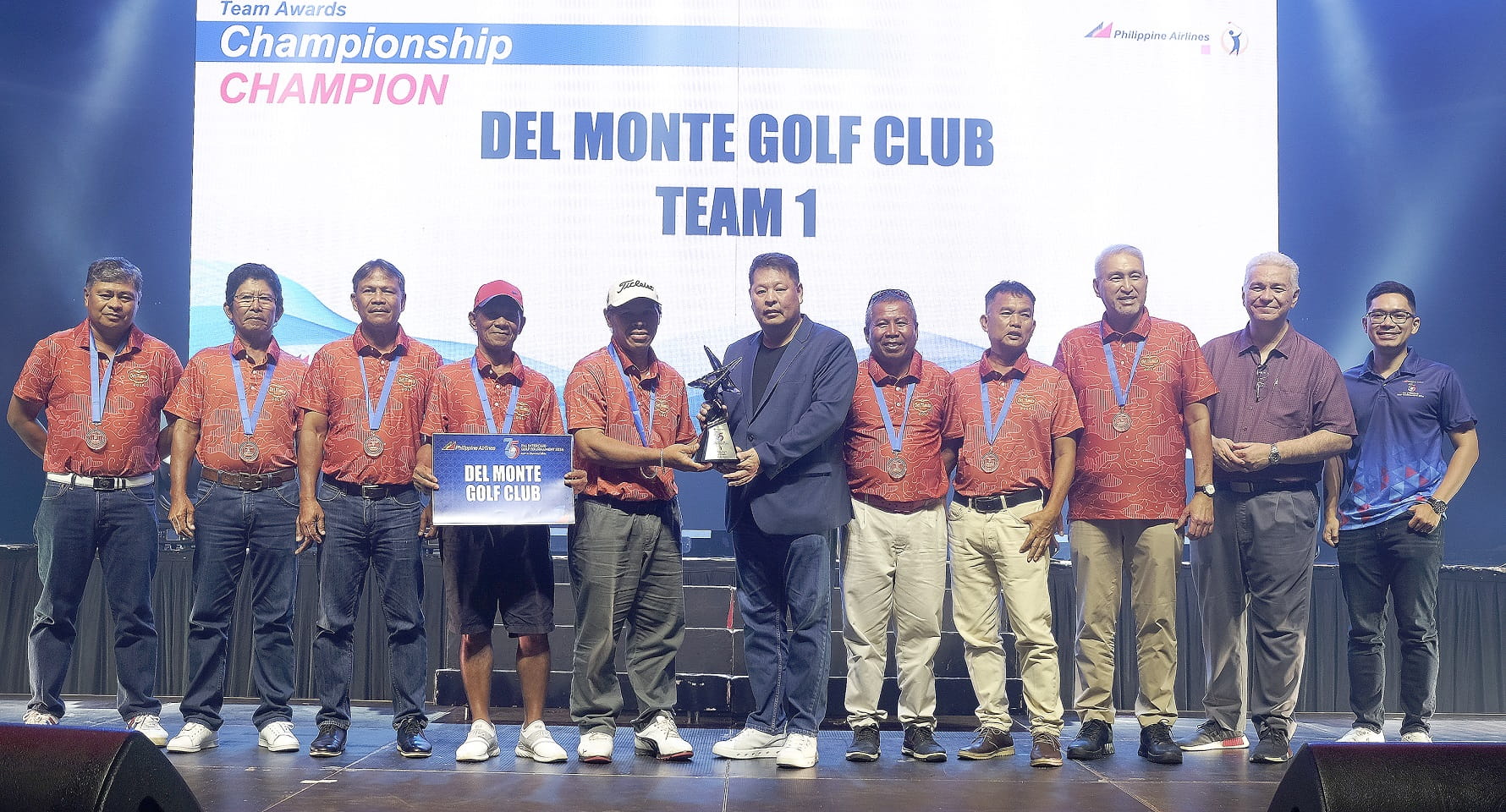 The Del Monte team receives their trophy.